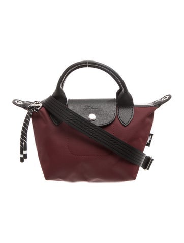 Burgundy Longchamp Le Pliage nylon handbag with short handles and a shoulder strap
